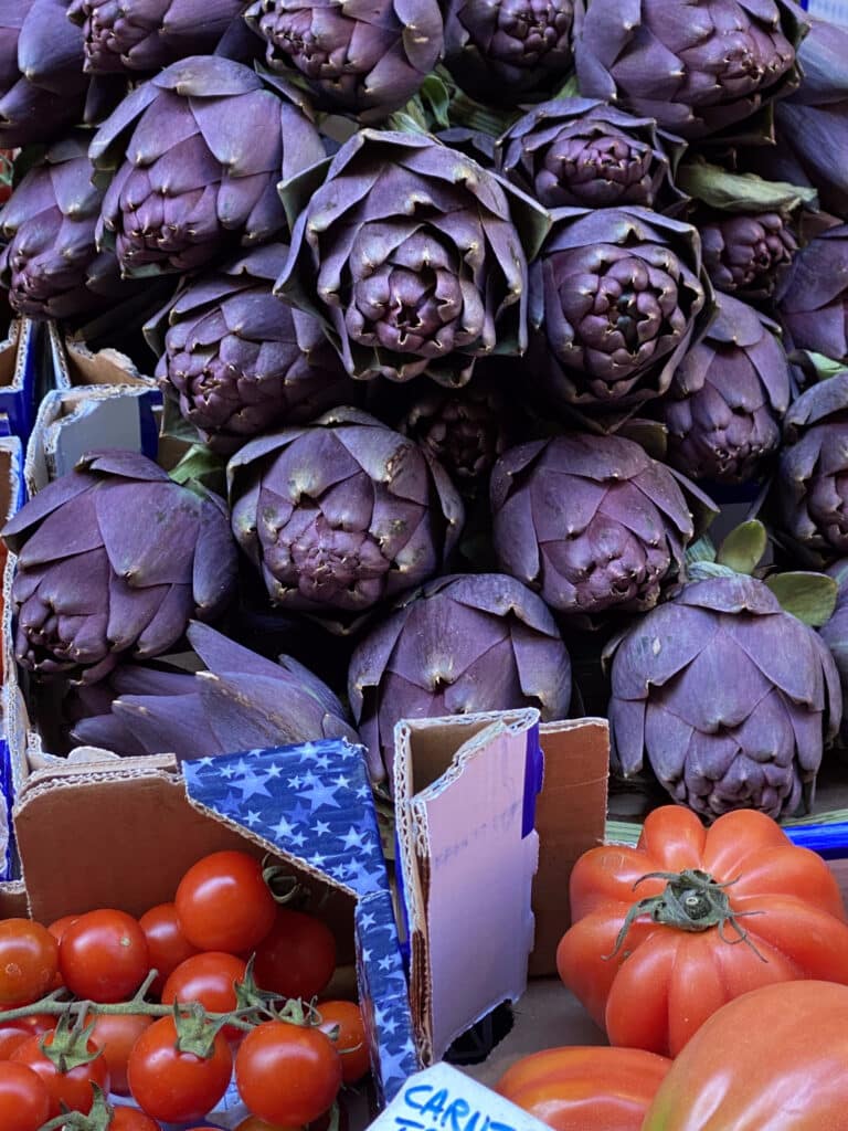 Market in Italy with artichokes and tomatoes