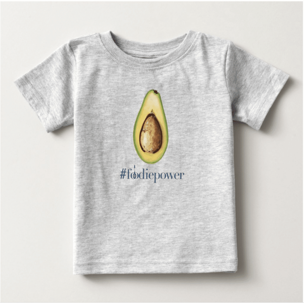 Grey jersey T-shirt for kids featuring an avocado print with the hashtag '#foodiepower' below.