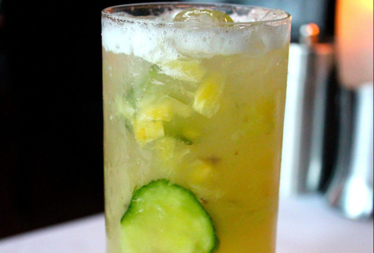 A tall cocktail with cucumber