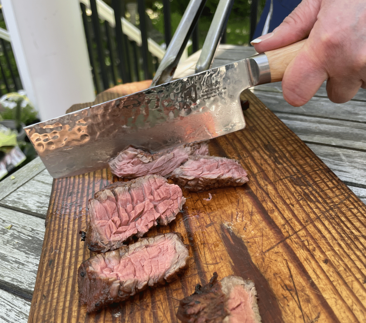 Steak on a plank being cut