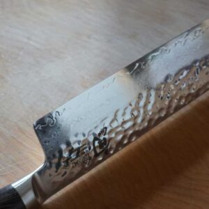 Detailed view of the blade of a Shun Premier Nakiri knife.