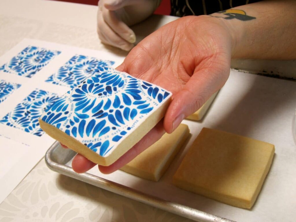 Completed Mexican tile cookie showcasing a vivid blue floral design.