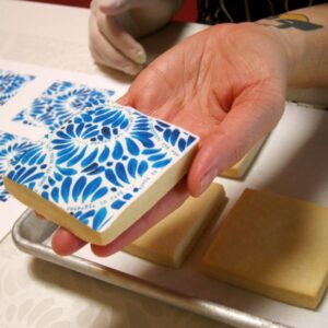 Completed Mexican tile cookie showcasing a vivid blue floral design.