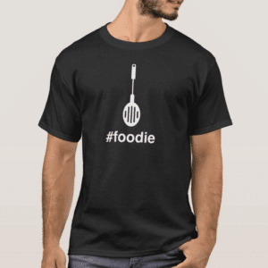 Man wearing a black t-shirt with a spatula graphic and the hashtag 