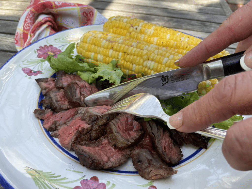 grilled steak and corn on plate