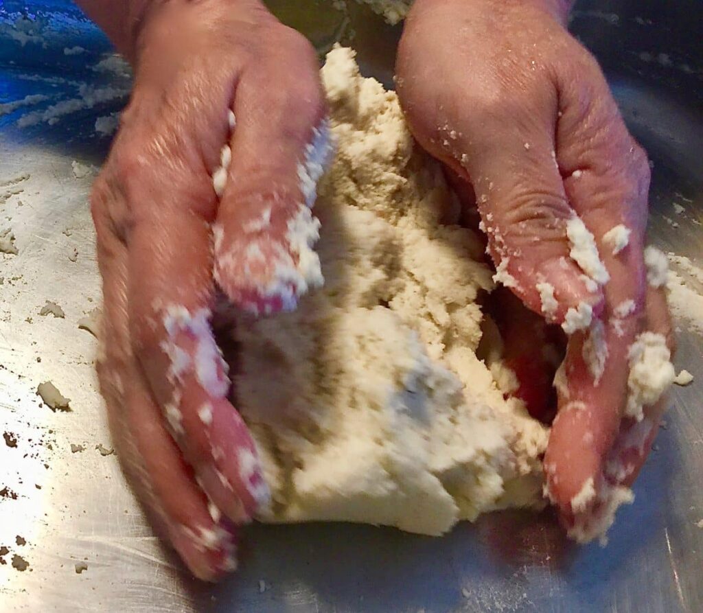 Hands kneading masa dough