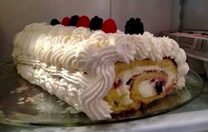 Close-up of a Lemon Berry Roulade with Mascarpone and Whipped Cream