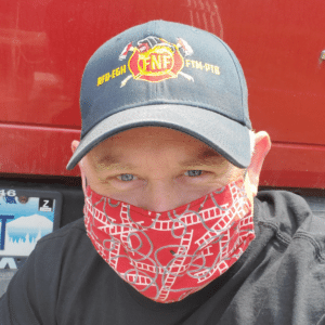 Man wearing a cap and red patterned face mask