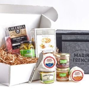 A boxed assortment of cheeses, crackers, and accompaniments for a picnic.