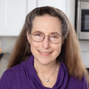 Portrait of Rose Levy Beranbaum wearing glasses and a purple shirt.