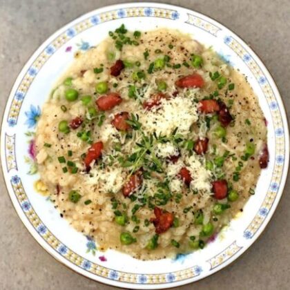 Plate of risotto with peas and bacon