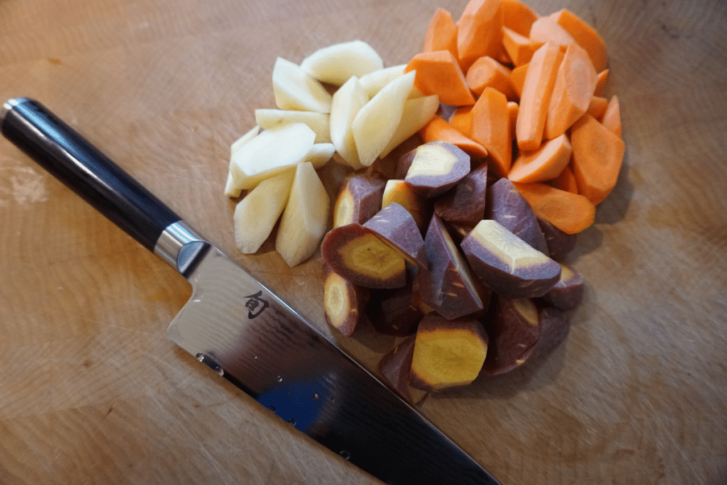 Shun Classic Asian Cook's Knife next to freshly cut gem vegetables.
