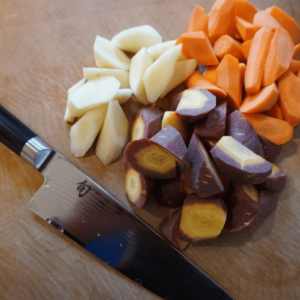 Shun Classic Asian Cook's Knife next to freshly cut gem vegetables.