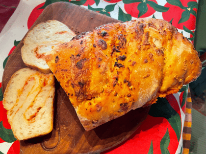 Sliced tomato Chees esourdough babka on wooden board