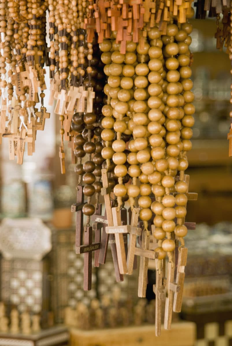 display of hanging wooded and beaded crosses
